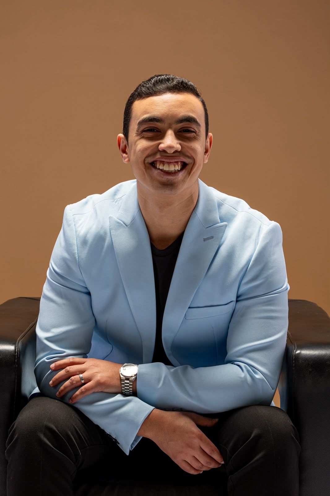 Dr. Ahmed Hussiny smiling in a light blue blazer